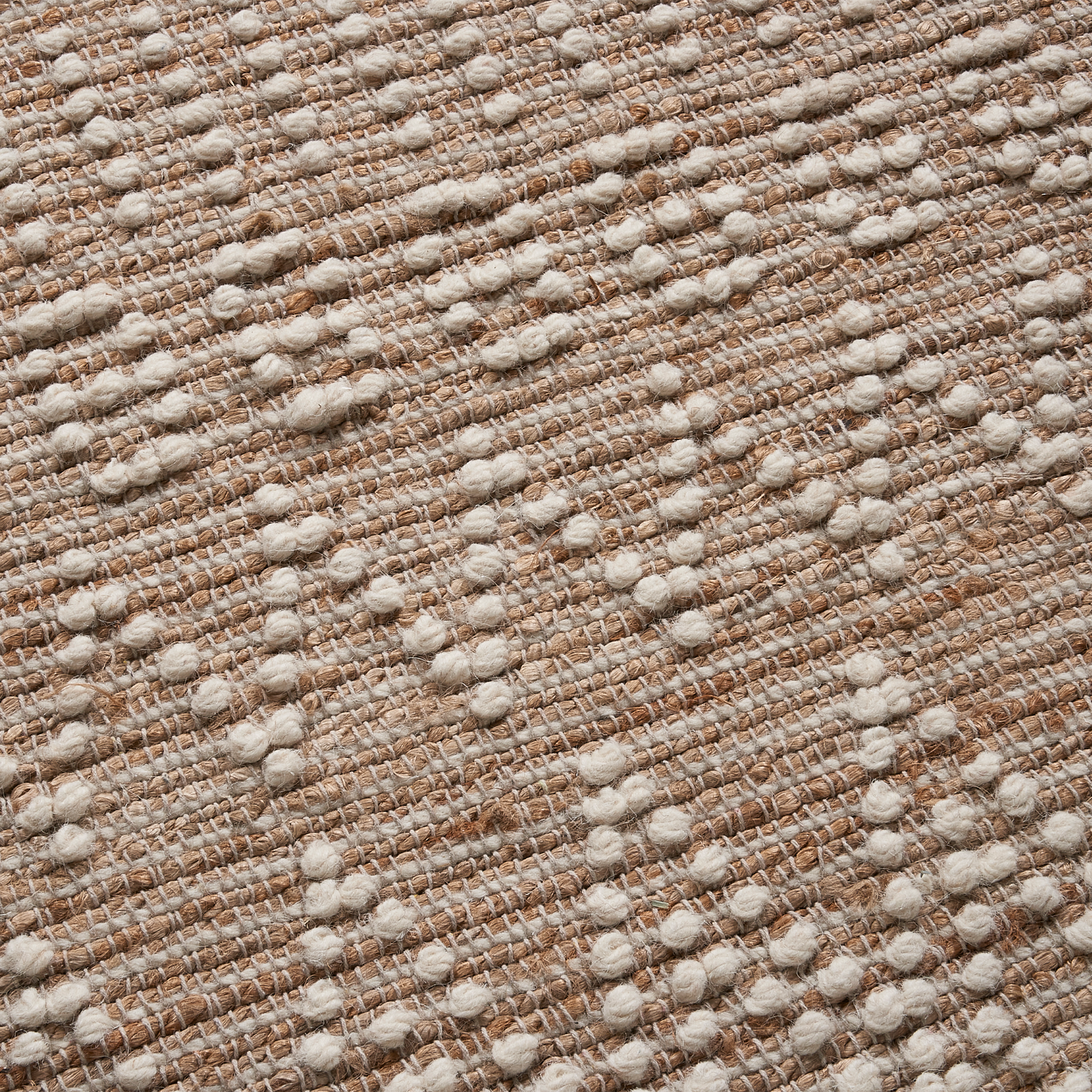 Texture close-up of natural and ivory diamond area rug raised diamond weave